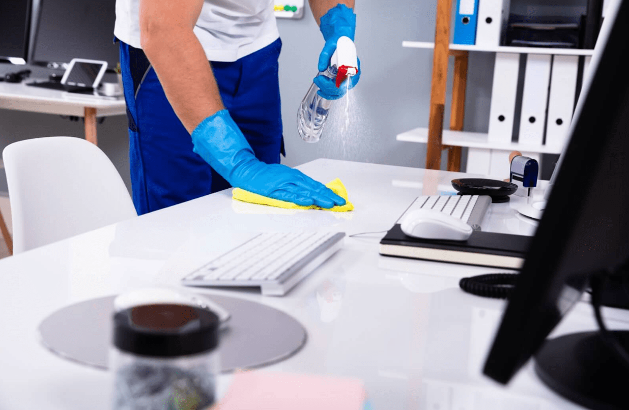 Cleaner cleaning a keyboard.