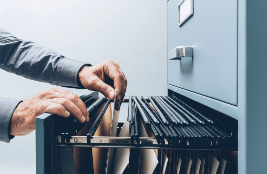 Person going through a filing cabinet.