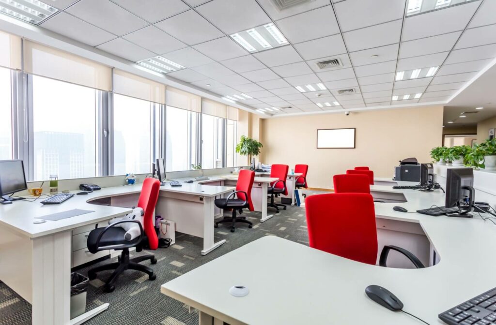 An office space with red chairs.