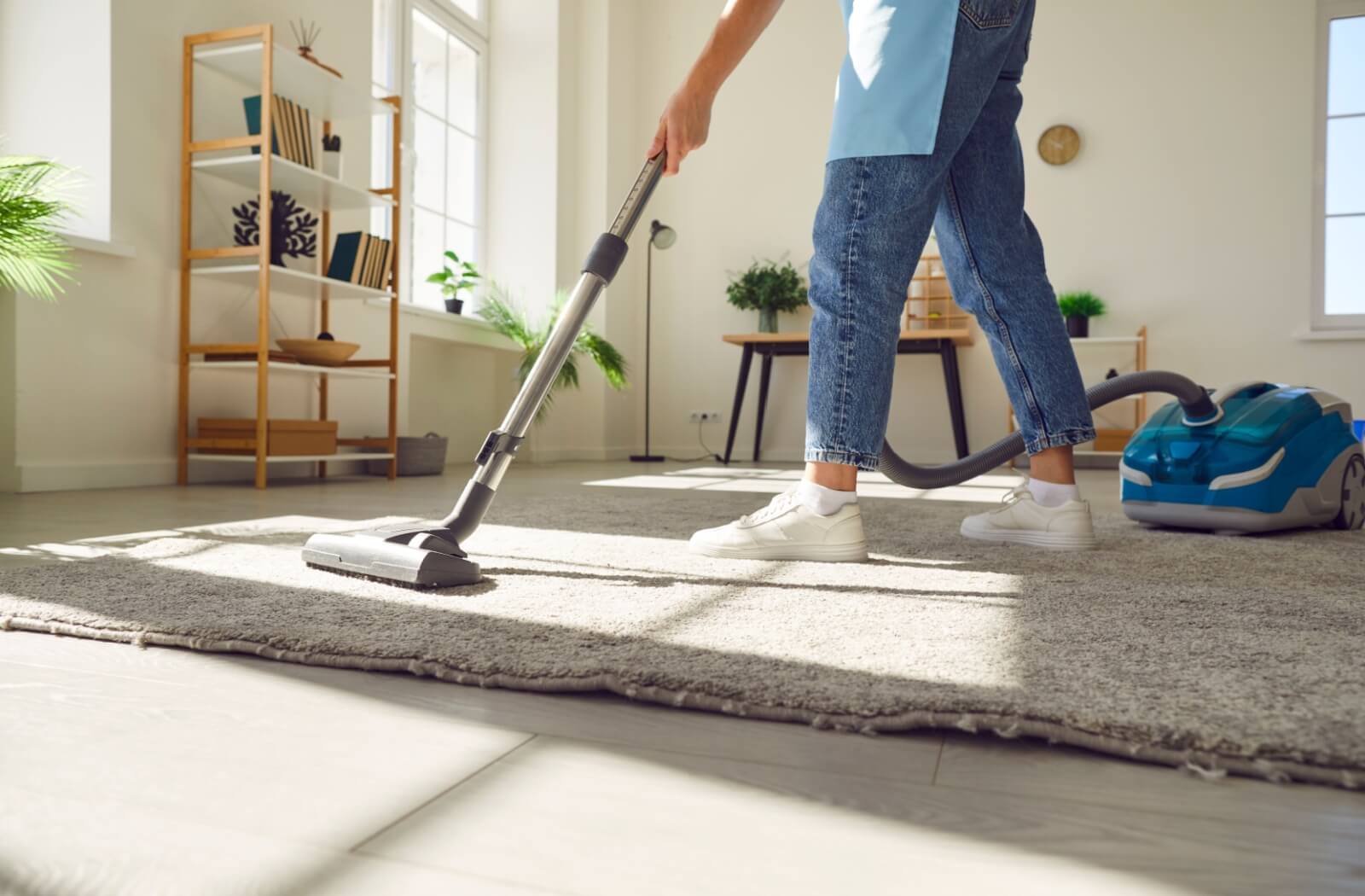 A professional cleaner dusting a table in a commercial office space