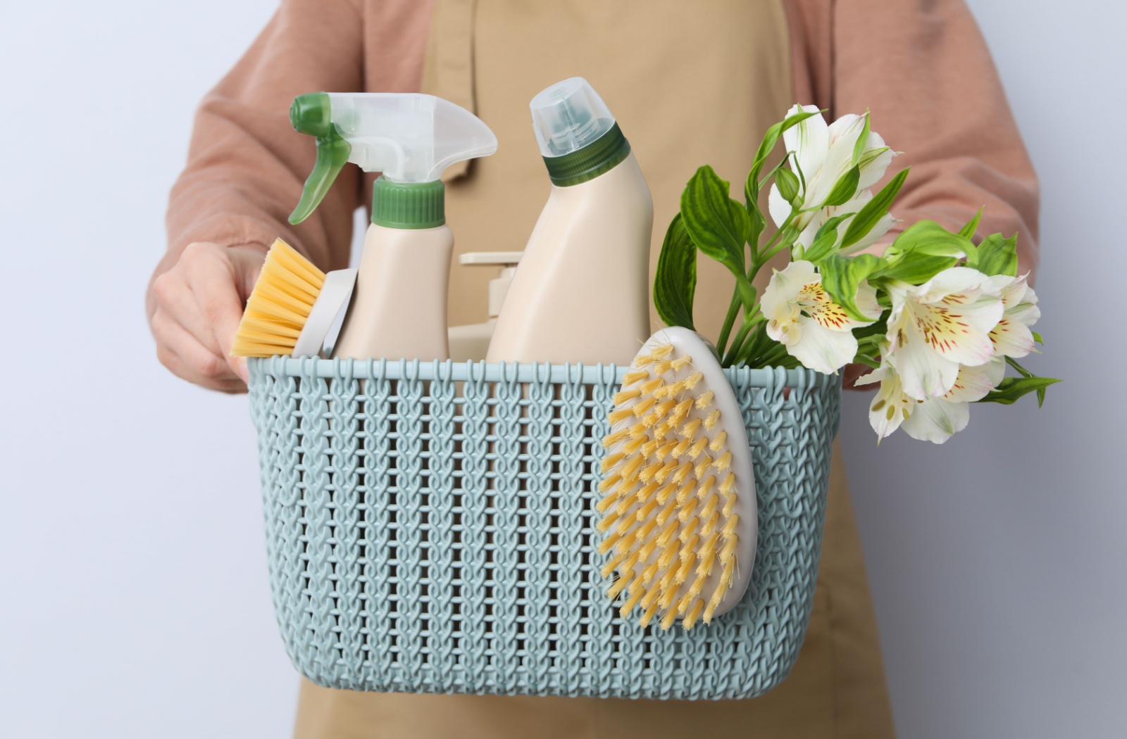 A close-up of a basket of spring cleaning supplies.