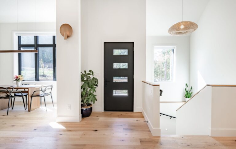 Bright sunlight shines into the windows of a brand new home that has just undergone post-construction cleaning.