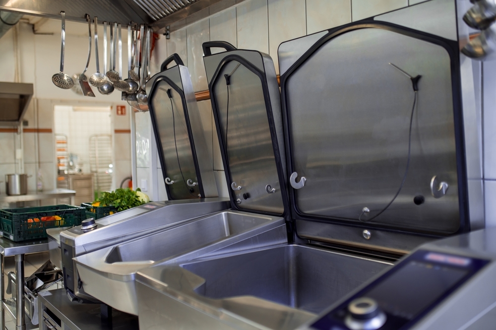 Very clean looking dishwasher area in a commercial kitchen.